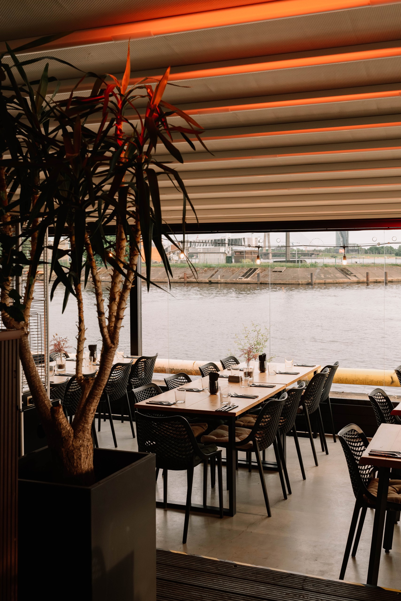 Tables by the riverside glass at Koya